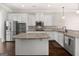 Modern kitchen featuring white cabinets, stainless steel appliances, granite countertops, and a center island at 6857 Louis Dr, Locust Grove, GA 30248