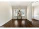 Spacious living room showcasing hardwood floors, a display shelf, natural light, and elegant trim at 6857 Louis Dr, Locust Grove, GA 30248