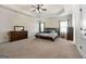 Spacious main bedroom with trey ceiling, plush carpet and neutral decor at 6857 Louis Dr, Locust Grove, GA 30248