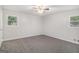 Bedroom with neutral carpet, ceiling fan and two windows at 125 Lafayette Dr, Fayetteville, GA 30214