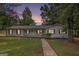 Charming home with a landscaped front yard and a quaint walkway leading to the entrance at 125 Lafayette Dr, Fayetteville, GA 30214