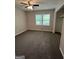 Cozy bedroom with plush carpeting, a ceiling fan, a closet, and a large window at 125 Lafayette Dr, Fayetteville, GA 30214