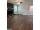 Spacious living room with dark wood floors, a fireplace with a black brick surround at 125 Lafayette Dr, Fayetteville, GA 30214