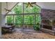 Inviting back porch with wood burning fireplace, ceiling fans and views of mature trees at 319 Beaconsfield Dr, Sharpsburg, GA 30277