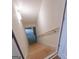 Unfinished basement stairs lead to potential living space with handrail and overhead lighting at 319 Beaconsfield Dr, Sharpsburg, GA 30277