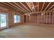 Unfinished basement features an exterior door, window, and exposed framing at 319 Beaconsfield Dr, Sharpsburg, GA 30277
