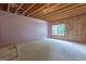 Unfinished basement with exposed ceiling, insulation, and a bright window at 319 Beaconsfield Dr, Sharpsburg, GA 30277