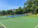 Community basketball court with mature trees and landscaping at 319 Beaconsfield Dr, Sharpsburg, GA 30277