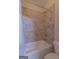 Bathroom featuring tiled shower/tub, shower head and controls and toilet at 319 Beaconsfield Dr, Sharpsburg, GA 30277