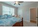 Carpeted bedroom with bed, window, ceiling fan, closet and doorway leading to another room at 319 Beaconsfield Dr, Sharpsburg, GA 30277