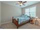 Bedroom with a bed, carpet floors, window, ceiling fan, and side table at 319 Beaconsfield Dr, Sharpsburg, GA 30277