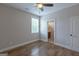 Bright bedroom featuring hardwood floors, a window, ceiling fan, and an ensuite bathroom at 319 Beaconsfield Dr, Sharpsburg, GA 30277