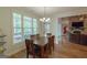 Inviting dining room featuring a wood table, natural light, and hardwood floors at 319 Beaconsfield Dr, Sharpsburg, GA 30277