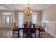 Bright dining room with wainscoting, chandelier, and wood floors at 319 Beaconsfield Dr, Sharpsburg, GA 30277