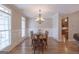 Elegant dining room featuring wainscoting, wood floors, and a chandelier at 319 Beaconsfield Dr, Sharpsburg, GA 30277