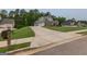 Long driveway leading to a well-maintained home with mature trees and a large front yard at 319 Beaconsfield Dr, Sharpsburg, GA 30277