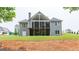 Back exterior of home features a covered deck and spacious backyard at 319 Beaconsfield Dr, Sharpsburg, GA 30277