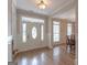 Bright foyer with tile wood floors and a decorative front door with sidelights at 319 Beaconsfield Dr, Sharpsburg, GA 30277