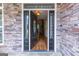 Elegant front door with decorative glass detailing, framed by stone accents and hardwood floors visible inside at 319 Beaconsfield Dr, Sharpsburg, GA 30277