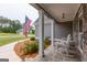 Charming covered front porch with rocking chairs and a view of the landscaped front yard at 319 Beaconsfield Dr, Sharpsburg, GA 30277