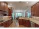 Spacious kitchen with custom cabinetry and granite countertops open to the dining area at 319 Beaconsfield Dr, Sharpsburg, GA 30277