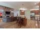 Open concept kitchen with granite counters, stainless appliances, and a stone fireplace at 319 Beaconsfield Dr, Sharpsburg, GA 30277
