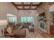 A generously sized living room features a stone fireplace, wood floors, and a large sectional sofa at 319 Beaconsfield Dr, Sharpsburg, GA 30277