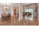 Open-concept living space with a dining area, hardwood floors, and ample natural light at 319 Beaconsfield Dr, Sharpsburg, GA 30277