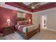 Beautiful main bedroom featuring a tray ceiling, ceiling fan, and two nightstands at 319 Beaconsfield Dr, Sharpsburg, GA 30277