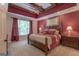 A grand main bedroom with coffered ceiling, ceiling fan, and large windows at 319 Beaconsfield Dr, Sharpsburg, GA 30277