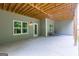 Spacious covered patio featuring a concrete floor, neutral walls, and natural lighting through adjacent windows at 319 Beaconsfield Dr, Sharpsburg, GA 30277