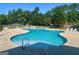 Resort style community pool with lounge chairs and mature trees offering a relaxing setting at 319 Beaconsfield Dr, Sharpsburg, GA 30277