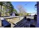 Back deck with a fire pit overlooking the backyard with a barn and a privacy fence at 701 Monticello Ln, Mcdonough, GA 30253