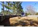 Backyard with a barn and a privacy fence and lots of shade trees at 701 Monticello Ln, Mcdonough, GA 30253