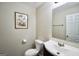 Powder room featuring modern fixtures, a dark vanity, and framed botanical art at 701 Monticello Ln, Mcdonough, GA 30253