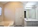 Bathroom featuring a shower/tub combo, vanity, and a large mirror at 701 Monticello Ln, Mcdonough, GA 30253
