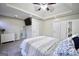 Bright bedroom with large closet, tray ceiling, and mounted tv above the bed at 701 Monticello Ln, Mcdonough, GA 30253