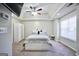 Spacious bedroom featuring tray ceiling, fan, carpet, and abundant natural light at 701 Monticello Ln, Mcdonough, GA 30253