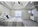 Bedroom featuring tray ceiling, fan, carpet, and abundant natural light at 701 Monticello Ln, Mcdonough, GA 30253