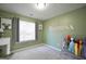 Cozy bedroom featuring soft carpet, a bright window, and playful wall decor at 701 Monticello Ln, Mcdonough, GA 30253