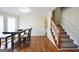 Dining room with hardwood floors, staircase, and bright windows at 701 Monticello Ln, Mcdonough, GA 30253