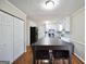 Bright kitchen featuring white cabinets, stainless steel appliances, and an island table with seating at 701 Monticello Ln, Mcdonough, GA 30253