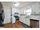 Bright kitchen featuring white cabinets and stainless steel appliances and hardwood floors at 701 Monticello Ln, Mcdonough, GA 30253