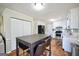 Bright kitchen featuring white cabinets, stainless steel appliances, and an island table with seating at 701 Monticello Ln, Mcdonough, GA 30253