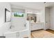 Bright bathroom features soaking tub, white cabinets, and updated vanity at 820 Dobby Way # 99, Mcdonough, GA 30252