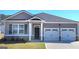 Charming single-story home featuring a gray exterior, two-car garage, and well-maintained lawn at 147 Oakchase Park Ln, Hampton, GA 30228