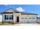 Charming one-story home with a two-car garage, showcasing a modern black and white color scheme at 147 Oakchase Park Ln, Hampton, GA 30228