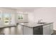 Eat-in kitchen boasts a granite counter top island and stainless steel dishwasher at 147 Oakchase Park Ln, Hampton, GA 30228