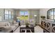 Elegant living room with large windows, stylish sofas, and decorative lamps at 147 Oakchase Park Ln, Hampton, GA 30228