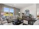 Inviting living room with large windows, comfortable seating, and a decorative cabinet at 147 Oakchase Park Ln, Hampton, GA 30228